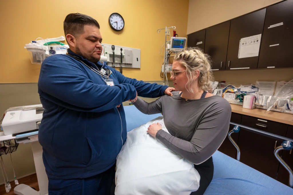 Complete Care staff member tending to patient.