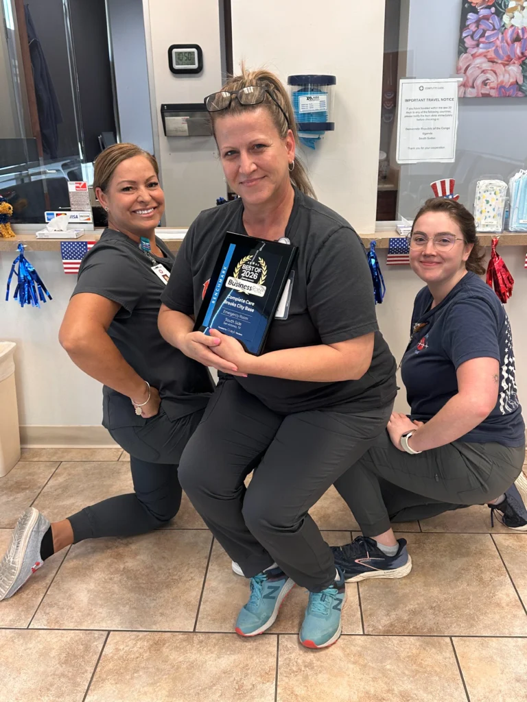 Complete Care Brooks City Base team holding 2026 Best of BusinessRate Award plaque